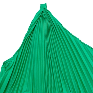Macro detail of vibrant green pleated fabric with fine textures and elegant shoulder ties