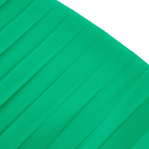 Detailed macro shot of the bright green pleated fabric texture and craftsmanship