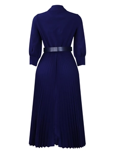 Rear view of a navy blue long-sleeve pleated dress featuring a high collar and waist tie belt