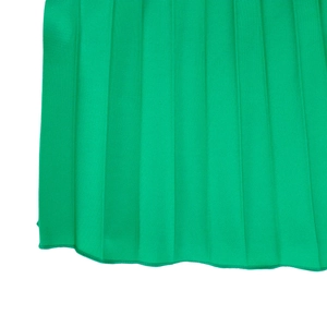 Detailed view of the pleated green fabric and fine hem stitching on the dress