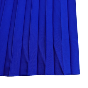 Macro shot of royal blue pleated dress fabric with high-density stitched hem detail