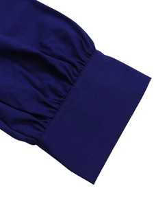 Close-up of dark blue dress sleeve showing elastic knit fabric and ruched cuff detail