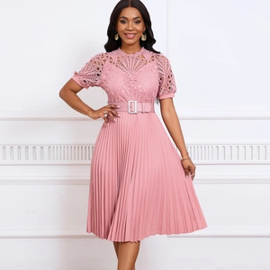 Detailed view of pink pleated dress with intricate lace stitching and waist belt