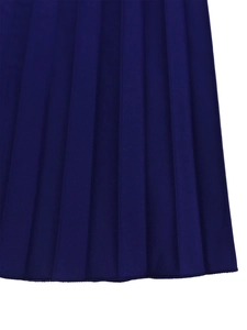 Macro detail of dark blue pleated fabric showing fine texture and uniform pleats