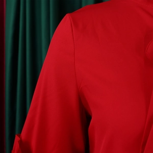 Detailed macro view of vibrant red dress shoulder seams and textured plain weave fabric