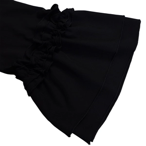 Detail view of double-layered ruffle cuffs on a black summer dress with delicate fabric texture