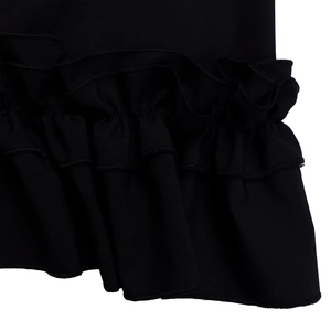 Detailed view of black tiered ruffle layers with fine stitching on a summer dress