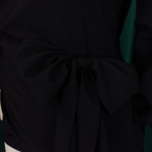 Detailed view of the elegant black wide bow tie on a fashion waist-tied blouse top
