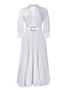 Detail of white pleated dress showing the lapel collar and waist belt with metal buckle