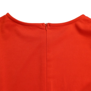 Detail of red pleated evening dress featuring back invisible zipper and honeycomb texture