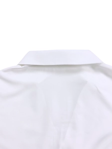 Detail view of the classic turnover collar and shoulder yoke on a white cotton shirt