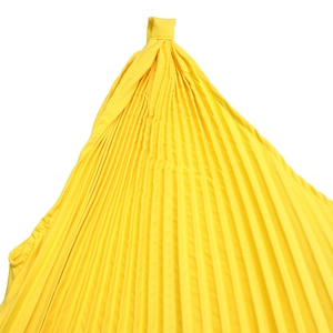Detail of bright yellow pleated fabric showing fine accordion folds on maxi dress