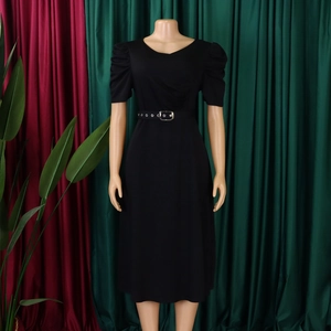 Detail of elegant black V-neck dress featuring puff sleeves and a silver ring buckle belt