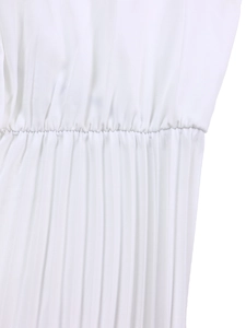 Macro detail of the high-waisted pleats and stitching on a white pleated dress