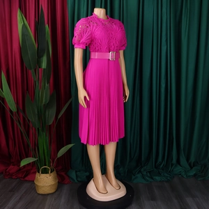 Detail of fuchsia pleated dress showing intricate floral lace stitching and puff sleeves
