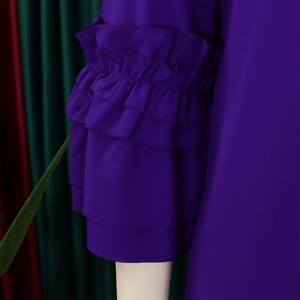 Close-up of elegant triple-layered ruffle flare sleeves on purple summer dress