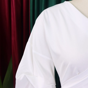 Detail of white puff sleeve shoulder with smooth satin texture and clean stitching