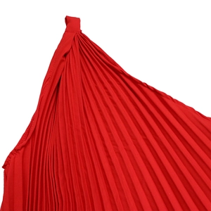 Detail of red pleated shoulder strap showing the fine vertical texture and draped fabric