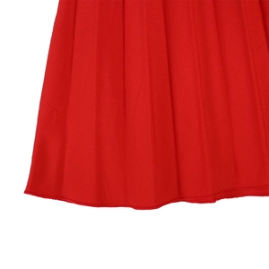 Detail of red pleated fabric with fine vertical accordion folds and hemmed edge stitching