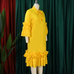 Detail of ruffled sleeves and bow tie neckline on this bright yellow summer dress