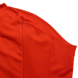 Detailed close-up of a high-quality invisible zipper on a red elegant jumpsuit fabric