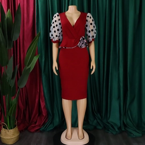 Detail of red V-neck pencil dress with white polka dot lantern sleeves and floral waist accent