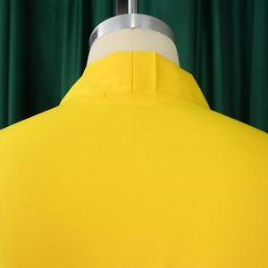 Detail of the back collar and shoulder seams on a bright yellow summer dress