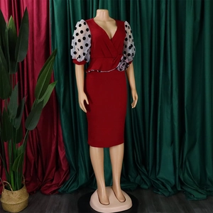 Detail of red pencil dress featuring polka dot mesh puff sleeves and floral waist ruffle