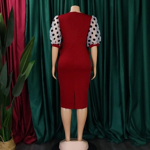 Detail view of burgundy pencil dress featuring white mesh puff sleeves with black polka dots
