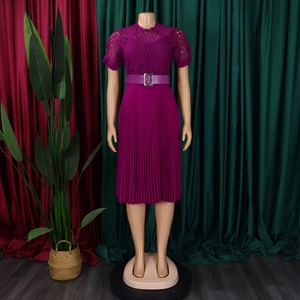 Detail of dark purple dress featuring intricate lace bodice and pleated skirt with belt