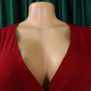 Detailed view of elegant red V-neckline with mesh flocked sleeves and fine stitching