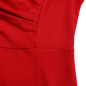 Detailed close-up of red pleated dress showing fine stitching and textured fabric finish