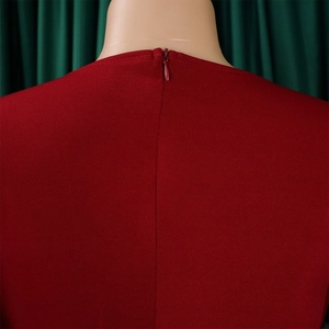 Detail of invisible zipper on the back of a red pencil dress with round neckline
