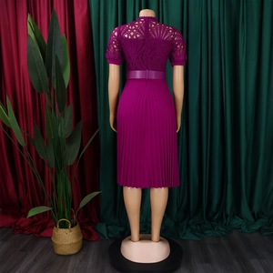Detail of magenta lace neckline and pleated skirt on a formal African party dress
