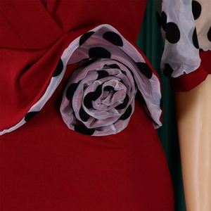 Detail of burgundy pencil dress featuring 3D mesh polka dot floral applique sleeves