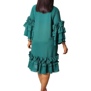 Detail of dark green dress showing layered ruffle sleeves and tiered hemline back view