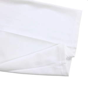 Detailed view of the hem stitching and fine texture on a white high-waist jumpsuit