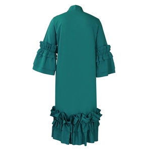 Detail view of teal green maxi dress showing multi-layered ruffle trumpet sleeves and hem