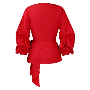 Detail of red puff sleeve blouse with adjustable self-tie waist and structured fabric