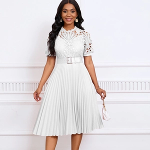 Detailed shot of white lace embroidery and pleated skirt with matching belt buckle