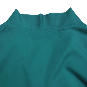 Detailed close-up of dark teal stand collar and textured fabric on casual dress