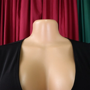Detail of elegant black dress showing V-neck design and mesh flocking puff sleeves