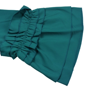 Detail of dark green tiered ruffle sleeves with fine machine-stitched edges on dress