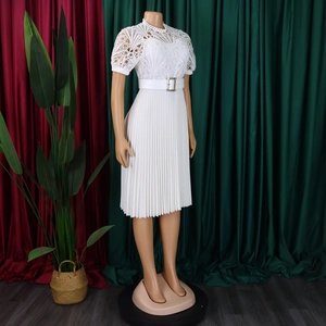 Detail of elegant white lace crochet bodice and pleated skirt with a waist belt