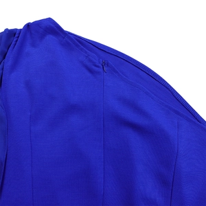 Detail of the invisible side zipper and fine stitching on high-waist royal blue jumpsuit
