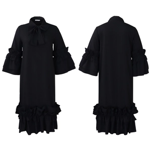 Detail view of black dress featuring bow neckline and multi-layered ruffle sleeves