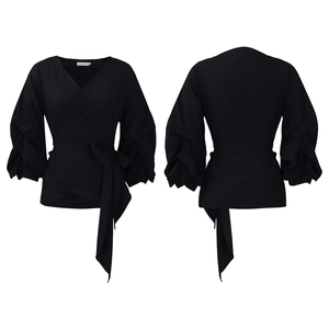 Detail view of black V-neck wrap blouse with puff sleeves and tie-waist design