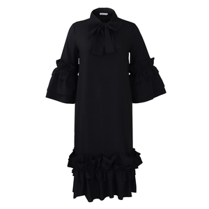 Detail view of the black midi dress featuring layered ruffle sleeves and a bow neckline