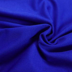 Detailed macro view of royal blue breathable mesh knit fabric with subtle texture folds