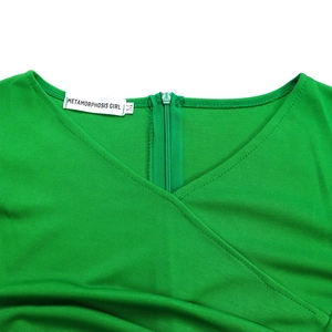 Close-up of V-neckline detail with green invisible zipper on textured fabric dress